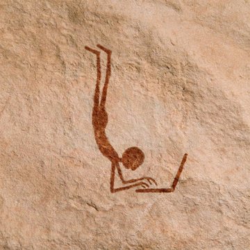 An ancient rock art painting depicts a human figure in an inverted handstand or diving position, drawn in reddish-brown pigment on a tan stone surface.