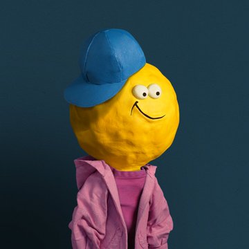A 3D-rendered character featuring a yellow lemon-shaped head with a smiling face, wearing a blue baseball cap and a pink jacket against a teal background.