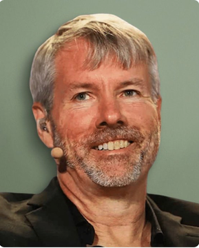 A portrait of a smiling middle-aged man with gray hair and a beard, wearing a black shirt and an ear-mounted microphone against a green background.