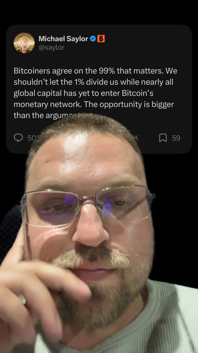 The image features a man wearing glasses, with his chin resting on his hand as he looks at the camera. The caption below him reads "Bitcoin is the new gold. We will continue to believe and continue to buy the dip. Bitcoiners will remain a group of chads." This statement seems to be related to the post about Bitcoin that was shared by Michael Smithson, who wrote it in response to a question about Bitcoin's value. The man with glasses appears to be expressing his opinion on this matter through the image.