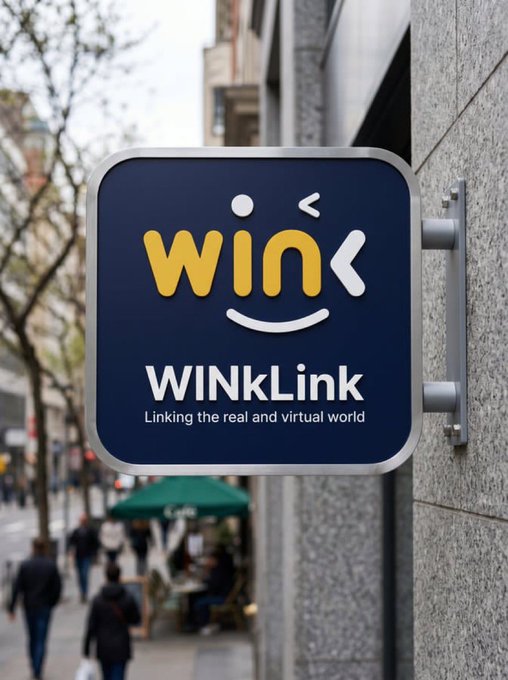 A wall-mounted sign displays the 'WINKLink' logo, featuring a stylized winking smiley face with the tagline 'Linking the real and virtual world' on a city street.