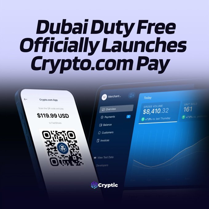 A promotional graphic announcing "Dubai Duty Free Officially Launches Crypto.com Pay," featuring a smartphone displaying a $119.99 USD QR code payment screen via the Crypto.com App alongside a merchant dashboard showing $8,410.32 in gross volume and 161 units sold, with the "Cryptic" logo at the bottom.