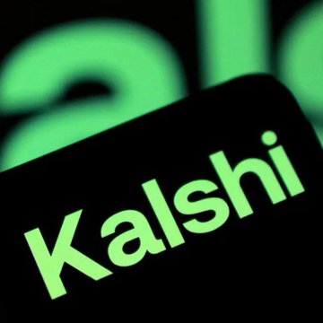 A close-up of a black device or sign displaying the green word “Kalshi,” with blurred green lettering behind it.