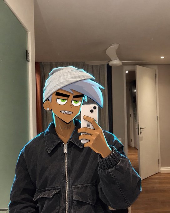 A mirror selfie features a person wearing a dark jacket and a grey beanie, with a cartoon-style filter applied that gives them light blue hair, a tan complexion, and green eyes.