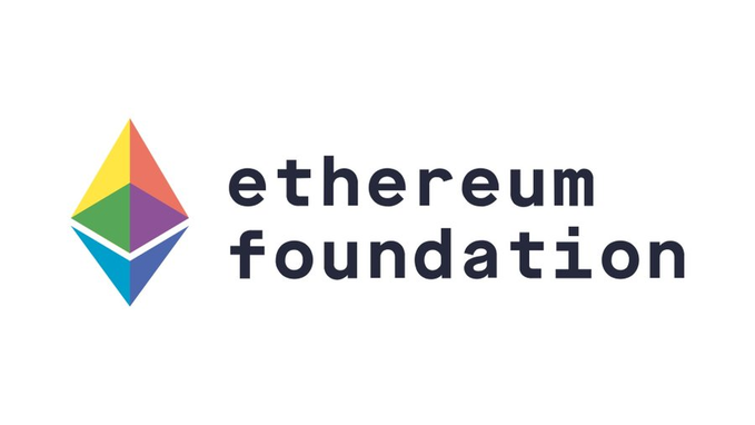 The image shows a white logo with a colorful shape of a triangle, which contains text that says "Ethereum Foundation" followed by "Reducing our staff by approximately 20%. This was done in early January. This new organization structure will begin on January 21st." The primary focus is the colorful shape above the words.