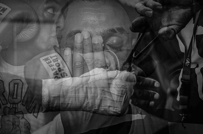 A black and white double-exposure photo captures a boxer's focused eyes layered over a gloved hand being taped and wrapped, with the name "Ben Fenn" visible on the hand wrap, reflecting the post's nostalgic "Cut" piece about the first night in an Antwerp boxing locker room in September 2022 that launched a series of memory-based 1/1 NFT artworks.