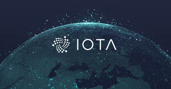 The IOTA cryptocurrency logo displayed over a digital globe with glowing particle effects.