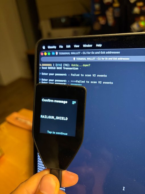 The image shows someone holding up their laptop screen, which displays an error message that reads "CONFIRM MESSAGE". This person appears to be trying to confirm a message or asking for help with an issue they are experiencing on their computer. The background of the image is blurred and does not provide any additional context about what might have caused the error message.