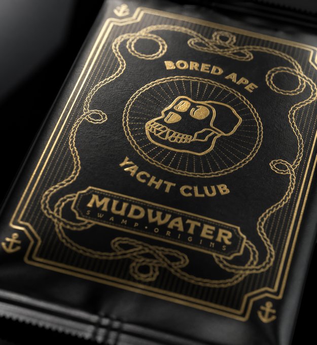 A close-up of a black card with gold embossed designs featuring a skull logo and the text 'Bored Ape Yacht Club MUDWATER Swamp Origins'.
