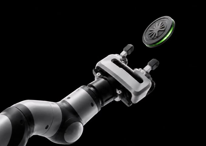 A 3D rendered robotic arm reaching toward a circular green-lit token or coin against a black background.