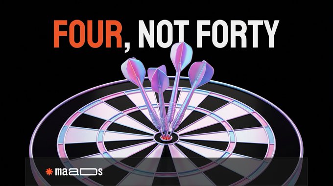 A promotional image featuring a dartboard with four darts hitting the bullseye, with the text 'FOUR, NOT FORTY' in orange and white at the top, and a 'maaDs' logo in the bottom left.