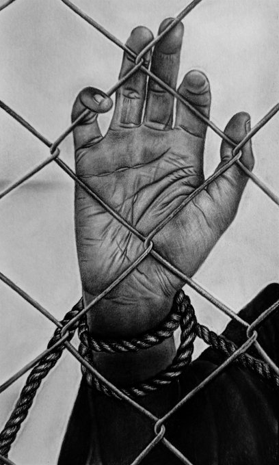 A black-and-white close-up photograph of a weathered hand pressed against a chain-link fence, with rope wrapped around the wrist.