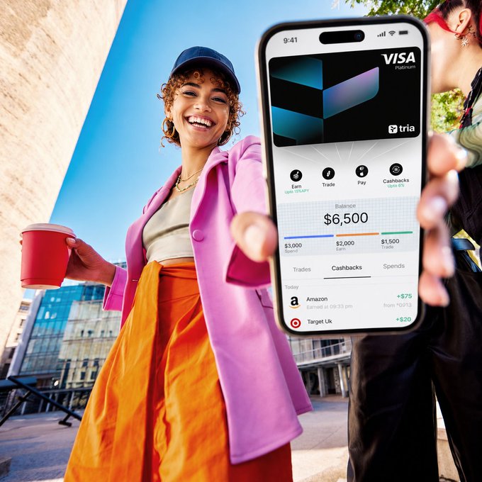 The image features a woman wearing an orange skirt and holding up her phone displaying a Visa credit card app. She is smiling and showing off her new purchase, while standing outdoors in front of some buildings or shops. The app indicates that she has just completed a transaction for $6.50, which the card company refers to as "Business Card". This suggests that she has spent money on something related to business expenses, and it's important for her to keep track of these transactions for tax purposes or other financial reasons. The image focuses on the woman with the credit card purchase, but the context around it is also relevant in understanding the use case of the app she is using.