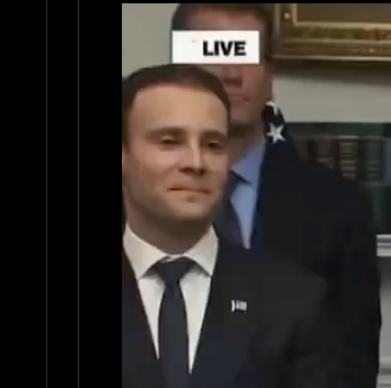 Emmanuel Macron appears in a live broadcast with a "LIVE" graphic in the upper right corner, standing in front of a bookshelf in formal attire, while the accompanying post mocks crypto holders who weathered the 10/10 market crash only to watch traditional stocks outperform their investments.