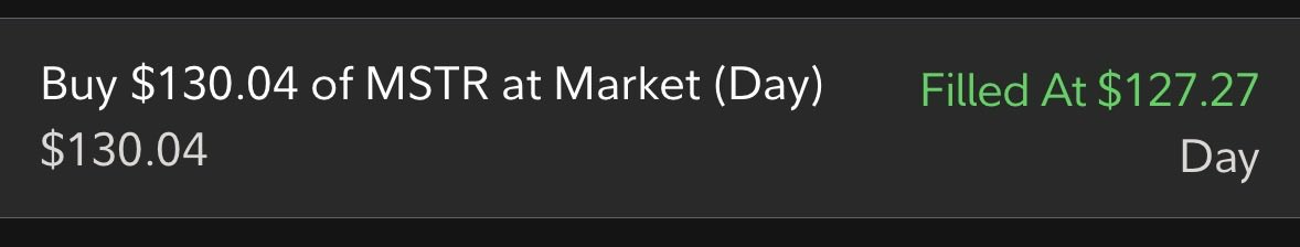 The image shows a brokerage order confirmation for buying $130.04 of MSTR at market price, filled at $127.27 during a day order. This corresponds to the post, where the user shares their recent MSTR purchase as part of accumulating Bitcoin exposure, noting they now hold 67 shares with an average cost of $202.