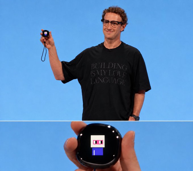 A man wearing glasses and a black 'BUILDING IS MY LOVE LANGUAGE' t-shirt holds up a small AI companion device displaying a pixelated face, with a close-up of the device shown below.