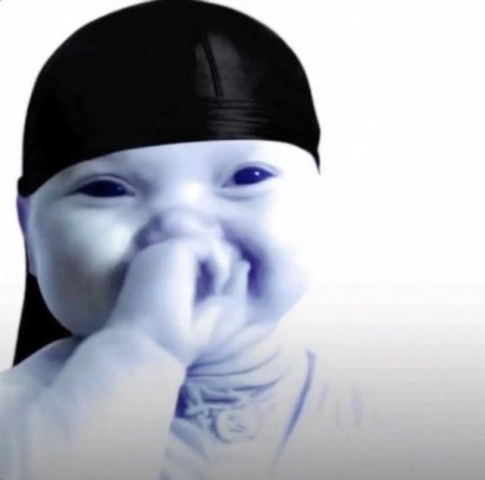 A child wearing a black cap holds their hand near their mouth in a gesture that playfully echoes the post "There oooo," as if caught mid-say. The image has a blue-tinted, slightly blurred filter giving it a candid, expressive quality.