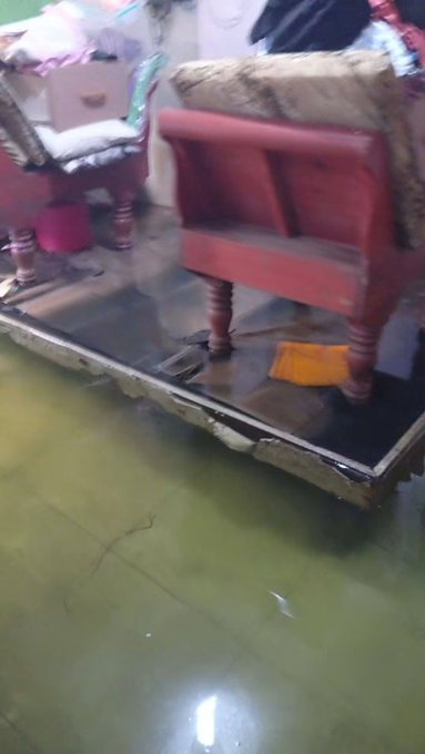 A slightly blurred image shows the back of a wooden chair with a cushion on top, sitting on a dark surface above a greenish floor, with another piece of furniture visible to the left. The image doesn't visually relate to the post about sending Solana cryptocurrency, as no text, numbers, addresses, or digital content are visible—likely shared as a casual visual from the streamer's environment.