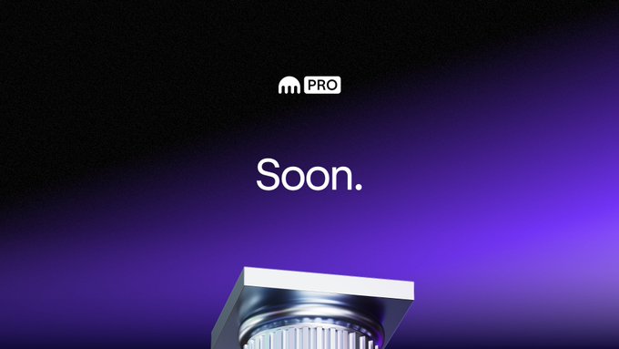 The image features a silver column with a white square base, positioned at the top center of the frame. Below the column, there's text that reads "Soon." This suggests that something significant or noteworthy is about to happen soon. The background of the image is dark purple, which contrasts with the silver color of the column and adds depth to the scene.