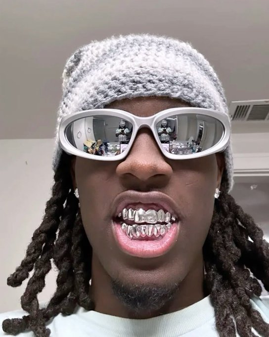 A man wearing a knitted cap and white-framed sunglasses shows off a set of diamond-encrusted grillz in a close-up selfie. The flashy accessories align with the casual "GM CT" (Good Morning CT) crypto-style greeting in the post, suggesting a "waking up active" vibe despite claiming inactivity.
