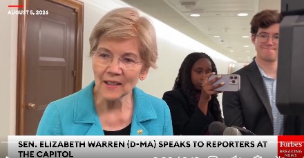 A news broadcast screenshot from Forbes dated August 5, 2024, showing Senator Elizabeth Warren (D-MA) speaking to reporters at the Capitol, with a young man holding up a smartphone visible in the background.