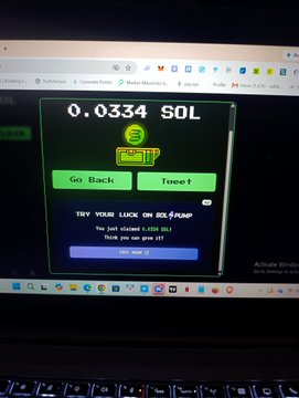 A laptop screen displays a withdrawal confirmation for 0.0334 SOL, aligning with the post's claim of receiving free Solana through "monothiez."