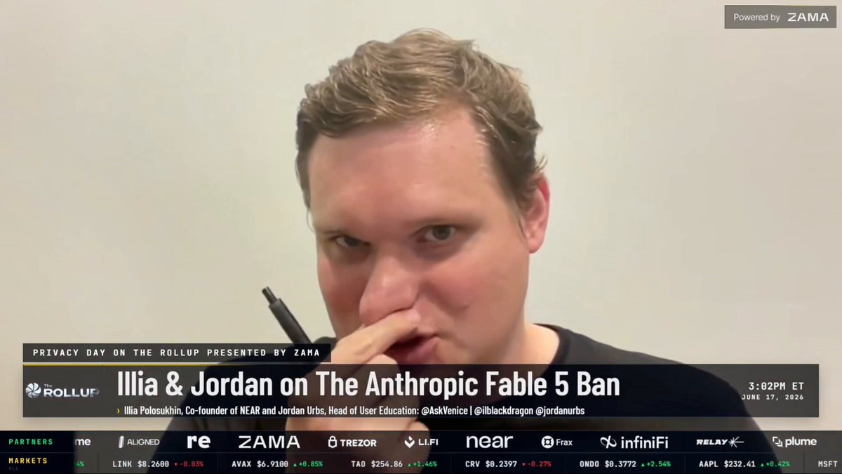 The image shows a man with short hair wearing a black shirt holding a pen over his nose as if sniffing or smelling something. The background of the image is white, which contrasts with the dark colors of the man's outfit. There are several logos in the image, including "Illia & Jordan on The Anthropic Fable 5 Ban", "Zama", and "Focus on what is in the image". These logos suggest that this image might be related to a discussion or presentation about AI models and their impact on people's lives.