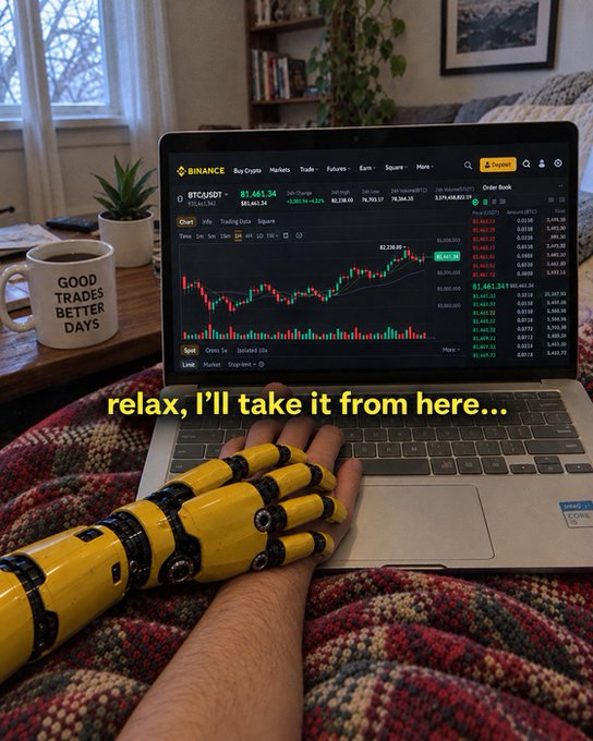 A person's yellow robotic prosthetic hand rests on a laptop displaying the Binance BTC/USDT trading chart, with a nearby mug reading "GOOD TRADES BETTER DAYS." The caption "relax, I'll take it from here..." humorously plays on the post's "Can you give me a hand?" joke, suggesting AI is ready to take over trading while the robotic hand literally provides one.