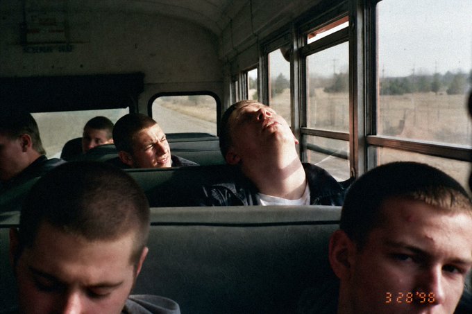 A photograph dated '3 28 '98' showing young men with shaved heads riding a bus, evoking the aesthetic of the film 'Kids.'