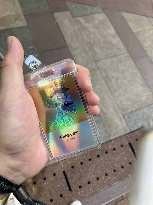 A hand holds an ID badge in a clear plastic holder featuring an iridescent holographic deer design and the text "Hisover 3D print."