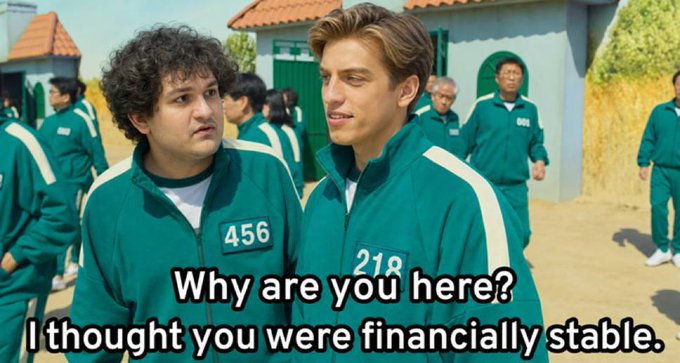 Two contestants from Squid Game—one labeled "456" and the other "218"—stand together in green tracksuits, with the caption reading "Why are you here? I thought you were financially stable." The meme humorously plays on the "GM" post by suggesting that even those who appear financially stable have ended up in high-risk situations, poking fun at crypto traders who "GM" (good morning) despite market struggles.