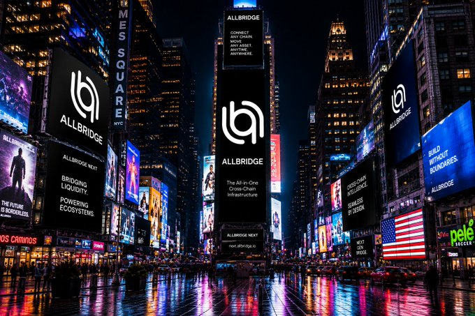 Massive digital billboards in a bustling city center at night display "ALLBRIDGE," a "Cross-Chain Infrastructure," with messaging like "BRIDGING LIQUIDITY," "POWERING ECOSYSTEMS," and "BUILD WITHOUT BOUNDARIES," visually echoing the caption's theme of capital moving fluidly across blockchain ecosystems without hesitation. The vibrant Times Square-like scene symbolizes the fast-paced, high-stakes environment where financial opportunities and risks shift instantly, demanding frictionless cross-chain solutions.