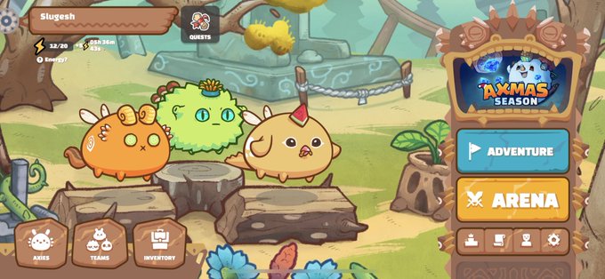 A screenshot from the mobile game Axie Infinity showing a player profile 'Slygesh' with Axie creatures (a green plant, orange beast, and yellow bird) in an Axmas Season interface with Adventure and Arena buttons.