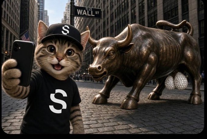 An AI-generated scene of a cat wearing a black cap and t-shirt featuring a dollar sign, taking a selfie next to the Wall Street Charging Bull statue, which has been humorously depicted with testicles made of pearls.