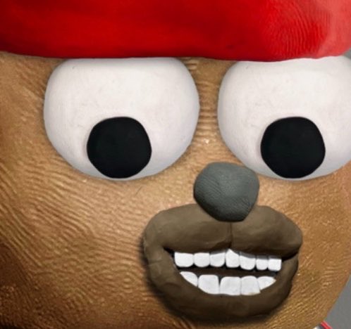 An extreme close-up of a brown teddy bear's face wearing a red Santa hat, showing its large white eyes, black pupils, black nose, and a wide smiling mouth with white teeth.