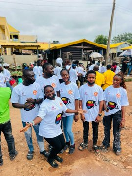 A group of people wearing matching white VeBetter t-shirts pose together outdoors at a community gathering, reflecting the post's message of translating on-chain VeBetter activity into real-world community engagement and participation.