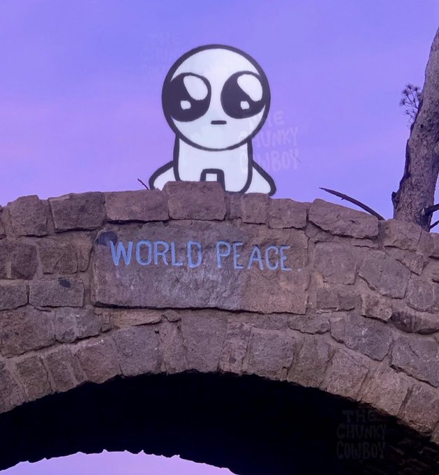 An illustration of a cute cartoon alien peeking over a stone wall with 'WORLD PEACE' written on it, against a purple sky background.