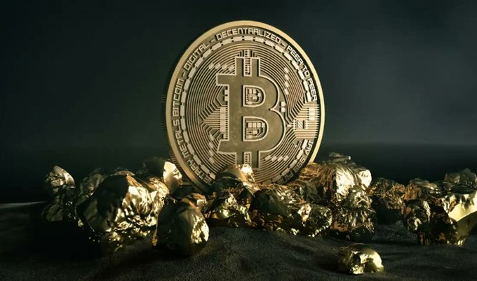 A physical gold-colored Bitcoin token stands upright among scattered gold nuggets on a dark surface, with the inscription "BITCOIN DIGITAL DECENTRALIZED PEER TO PEER" visible around its edge. The image visually reinforces the post's theme of Bitcoin miners accumulating reserves, as MARA Holdings sells 726 BTC ($46 million), reducing its holdings to 35,577 BTC and dropping to 4th place among corporate Bitcoin holders.