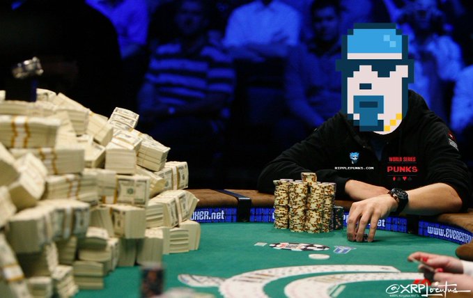 A poker player sits behind a towering stack of cash bundles and a modest pile of chips at a felt table, with a stylized pixel-art skull avatar (reflecting the "RipplePunks" theme) edited over their face, while the dealer area displays "PUNKS" branding and "StakerPunks.com" text—visually mirroring the post's hype about RipplePunks Reloaded buyers waking up the XRPL NFT collection.