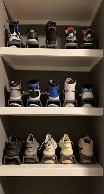 A closet shelf displays an organized sneaker collection featuring multiple pairs of athletic shoes, including Nike Air models and Yeezy-style sneakers, each displayed on individual risers. The post "Collectors Collect" aptly reflects the image, showcasing the owner's passion for curating and preserving a curated assortment of footwear.