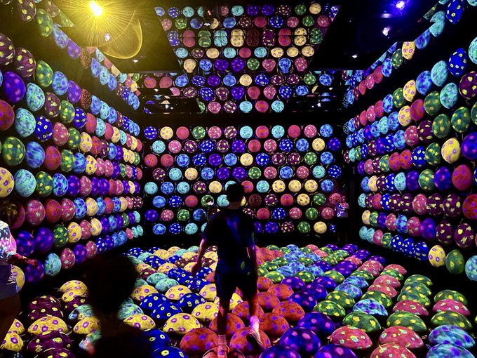 A person stands in a neon-lit immersive art installation filled with rows of glowing spherical orbs projecting colorful patterns on the walls, floor, and ceiling. The image bears no direct relation to the post, which is about struggling to gain visibility on X (formerly Twitter) despite using GoMining and other crypto hashtags.

The vibrant, disorienting scene may serve as a metaphor for the chaotic, overwhelming experience of trying to stand out in the crowded and noisy crypto community on social media, where many creators feel lost among thousands of competing posts and impressions.