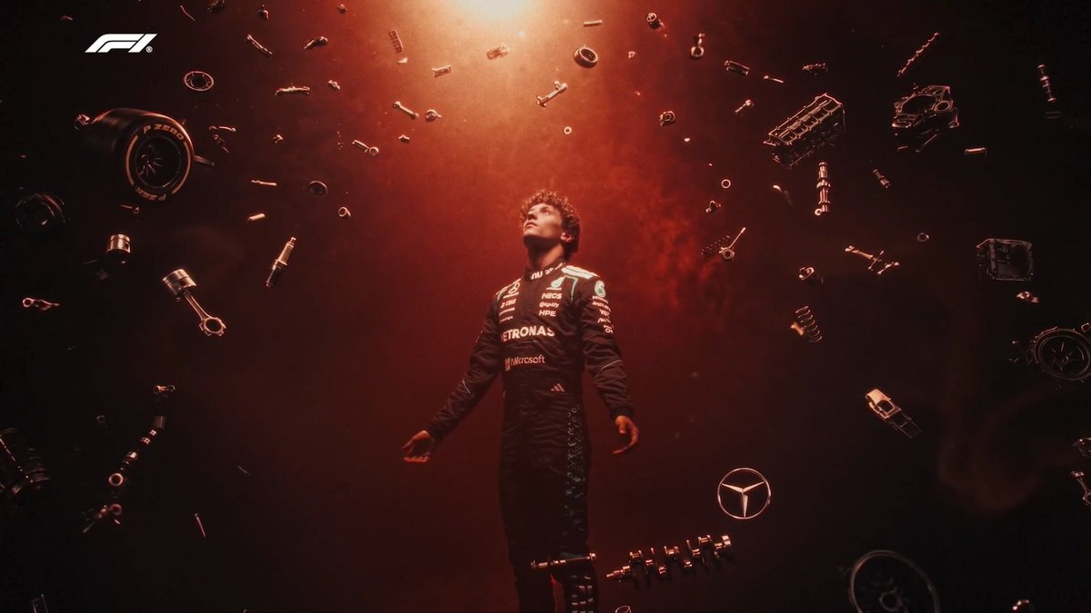 A dramatic promotional image from Formula 1 (F1 logo visible) showing a Mercedes-AMG Petronas F1 driver surrounded by floating car parts under red lighting, with the Mercedes star logo visible.
