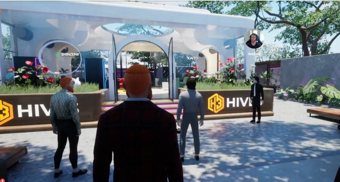 A screenshot from a virtual reality environment showing several avatars gathered near a modern pavilion structure branded with 'HIVE3' logos, with names like 'SHINZEN8', 'KAITO', and 'Adam' displayed above the avatars.