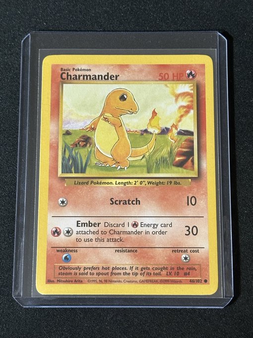 A graded 'Charmander' Pokémon trading card, number 46/102, is encased in a clear plastic protective slab.