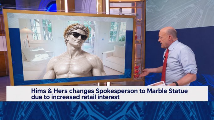 A television news segment shows a man presenting an image of a muscular marble statue wearing sunglasses; the on-screen text reads 'Hims & Hers changes Spokesperson to Marble Statue due to increased retail interest'.