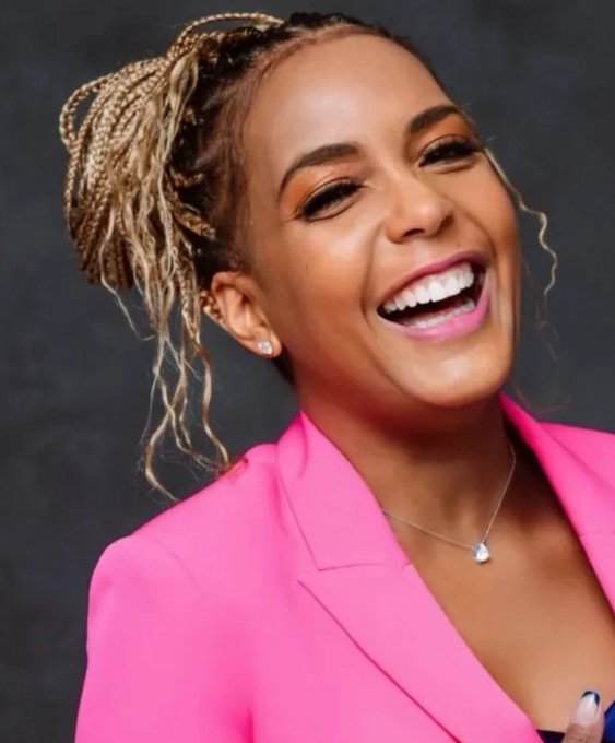 A smiling woman with braided hair wears a bright pink blazer and a necklace. The image appears to be a portrait of Keisha Lance Bottoms, shown in connection with the accompanying post about her leading the Georgia governor race on Polymarket at 61%.