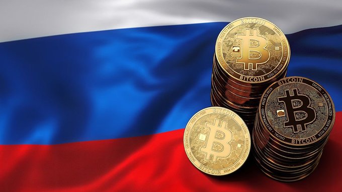 Stacks of gold Bitcoin coins featuring the "B" logo and the word "BITCOIN" are displayed in front of the Russian tricolor flag (white, blue, and red), symbolizing Russia's new crypto regulations that officially took effect on September 1st, allowing retail investors to buy up to 300,000 rubles (~$3,800) of top coins like BTC, ETH, and USDT annually after passing a knowledge test.