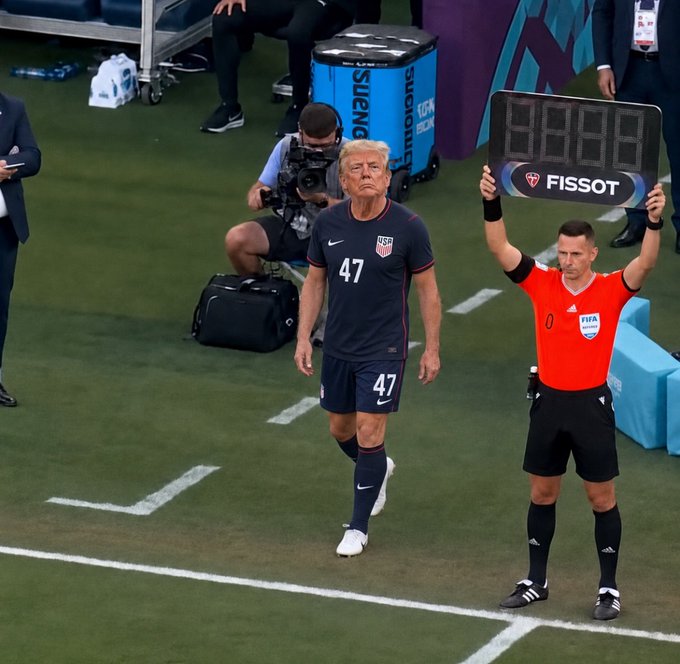 Donald Trump, wearing a USA soccer jersey with the number 47, walks onto the field beside a referee holding a Tissot scoreboard, as if he himself is the "secret weapon" being introduced into the game.