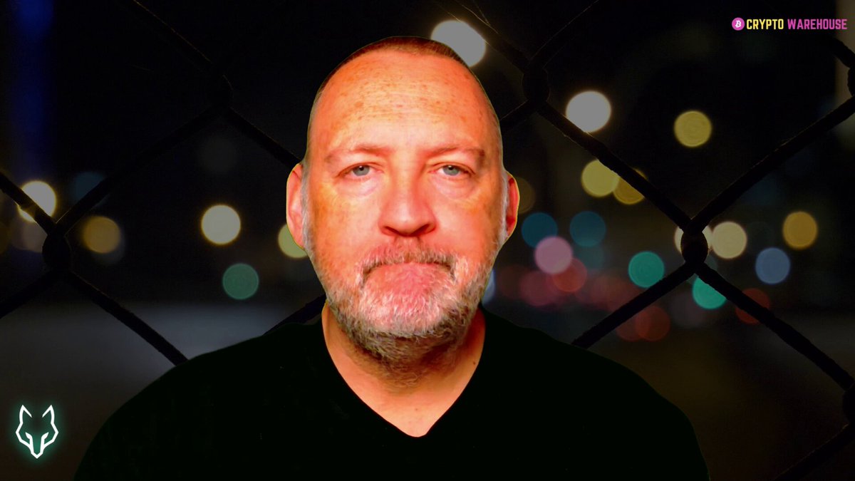 The image features a man wearing a black shirt who appears to be looking directly at the camera. The background of the image includes neon lights, suggesting that this photo was taken during nighttime or in an area with bright lighting conditions. The image also contains text elements such as "Dungeons Now Live" and "@solana", which may provide additional context about the content of the post.