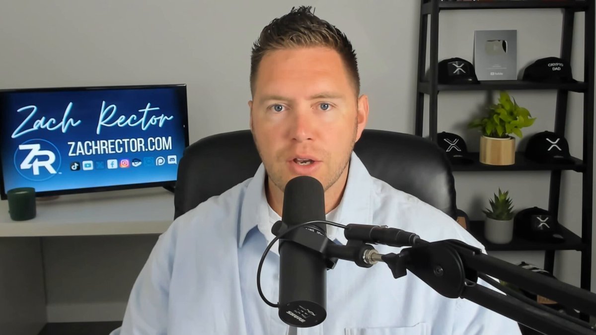 The image shows a man sitting at a desk with a microphone, likely preparing for or just finished recording an audio session. The background features a TV screen displaying the name "Zach Rector" along with some social media logos. There are also several potted plants in the room, adding a touch of greenery to the space.